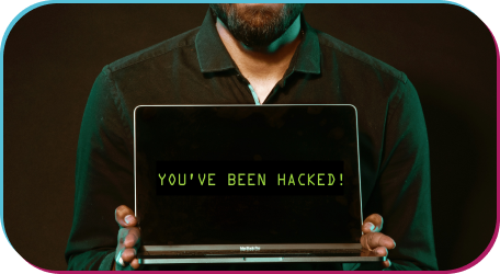 Man holding a computer saying he's been hacked